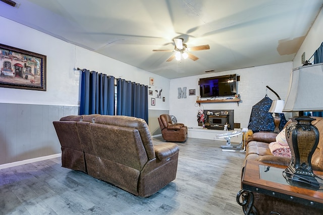 living room with wood-type flooring and ceiling fan