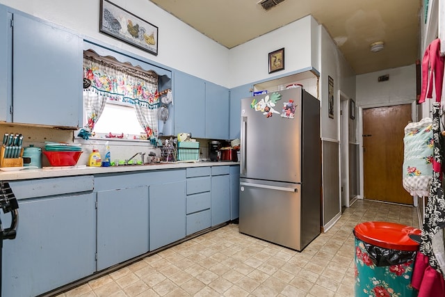 kitchen featuring stainless steel fridge and sink