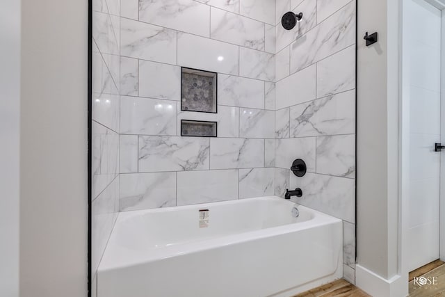 bathroom featuring hardwood / wood-style flooring and tiled shower / bath