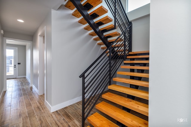 stairs featuring hardwood / wood-style flooring