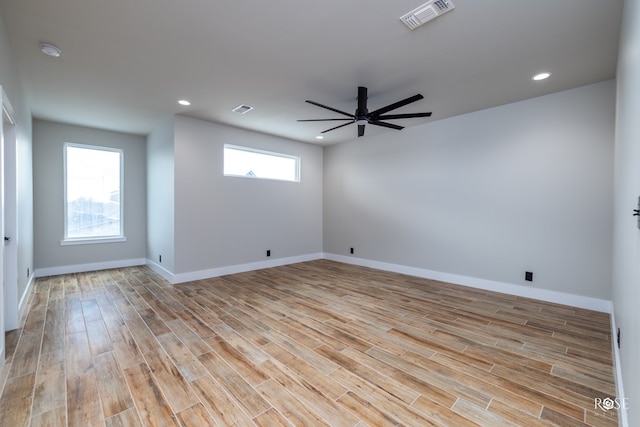 empty room with ceiling fan and light wood-type flooring