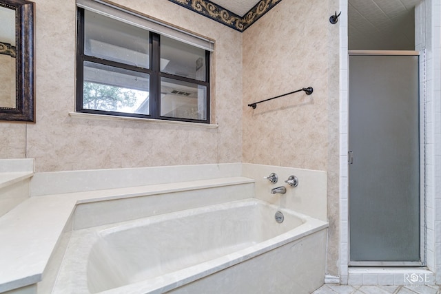 bathroom featuring tile patterned floors and shower with separate bathtub