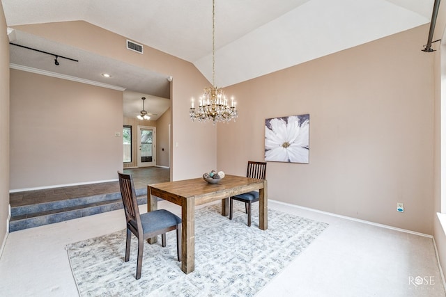 dining space with lofted ceiling, ceiling fan with notable chandelier, and carpet