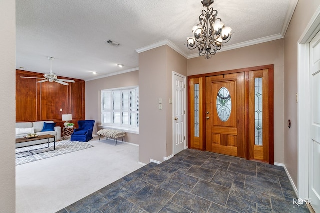 entrance foyer with a notable chandelier, dark colored carpet, a textured ceiling, and crown molding