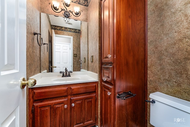 bathroom featuring vanity and toilet