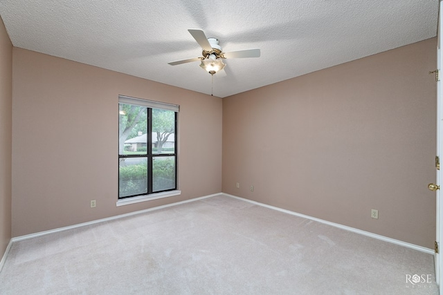 empty room featuring light carpet, a textured ceiling, and ceiling fan