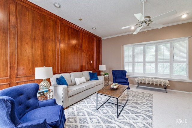 carpeted living room featuring crown molding, ceiling fan, and a textured ceiling