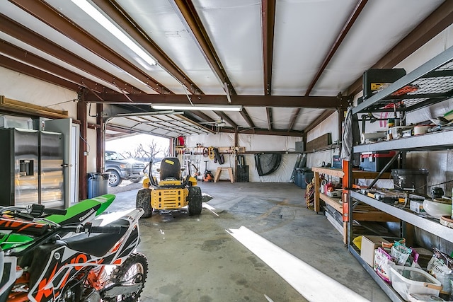 garage with stainless steel refrigerator with ice dispenser