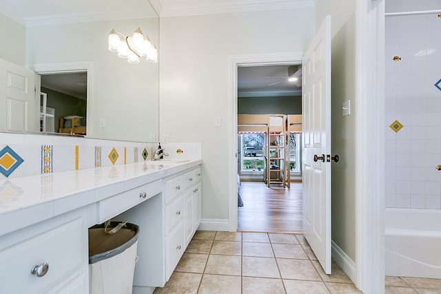 bathroom with tile patterned flooring, vanity, and crown molding