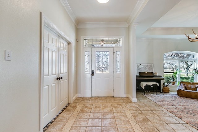 entryway featuring a notable chandelier, crown molding, light tile patterned floors, and a healthy amount of sunlight