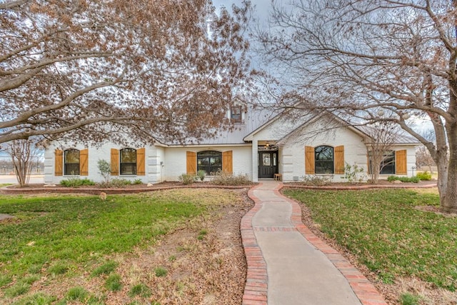 ranch-style home featuring a front yard