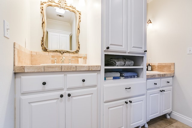 bathroom featuring ornamental molding and vanity