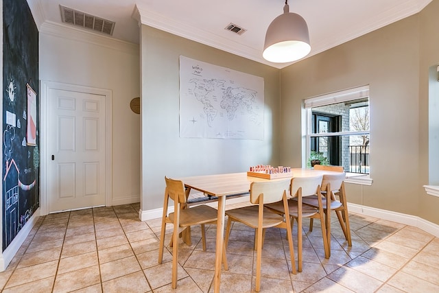 dining room featuring crown molding and light tile patterned floors