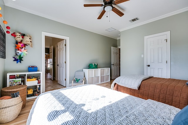 bedroom with ornamental molding, light hardwood / wood-style floors, and ceiling fan