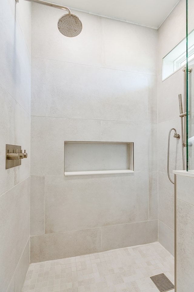 bathroom with a tile shower