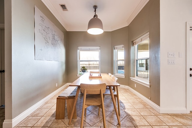 dining space with crown molding and light tile patterned flooring