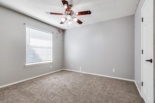 carpeted empty room with baseboards, a ceiling fan, and a textured ceiling