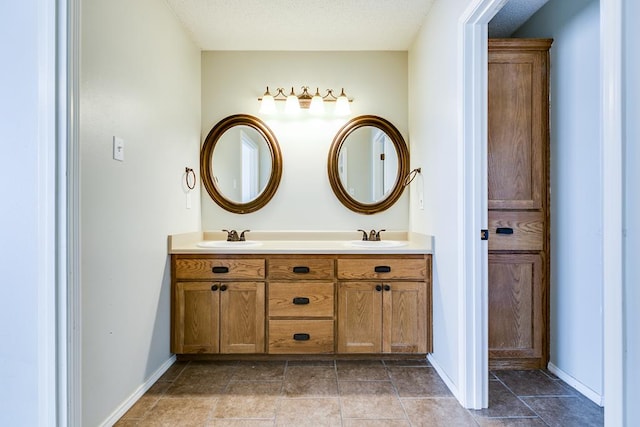 full bath featuring a sink, baseboards, and double vanity