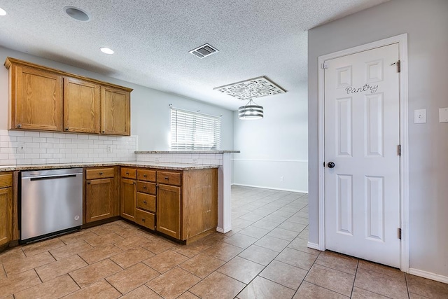 kitchen featuring a peninsula, stainless steel dishwasher, visible vents, and brown cabinets