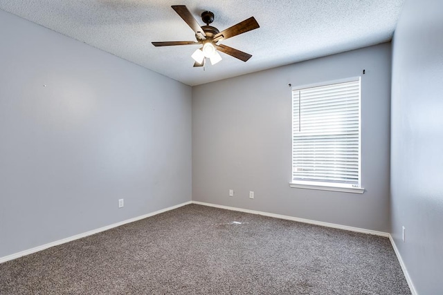 carpeted spare room with a ceiling fan, a textured ceiling, and baseboards