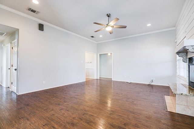 unfurnished living room featuring crown molding, visible vents, a large fireplace, ceiling fan, and wood finished floors