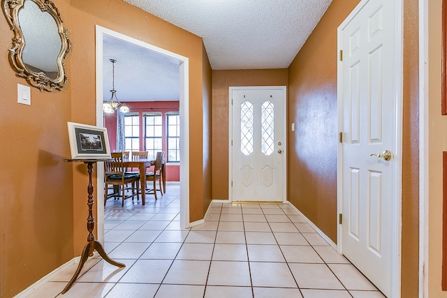 tiled entrance foyer featuring a textured ceiling