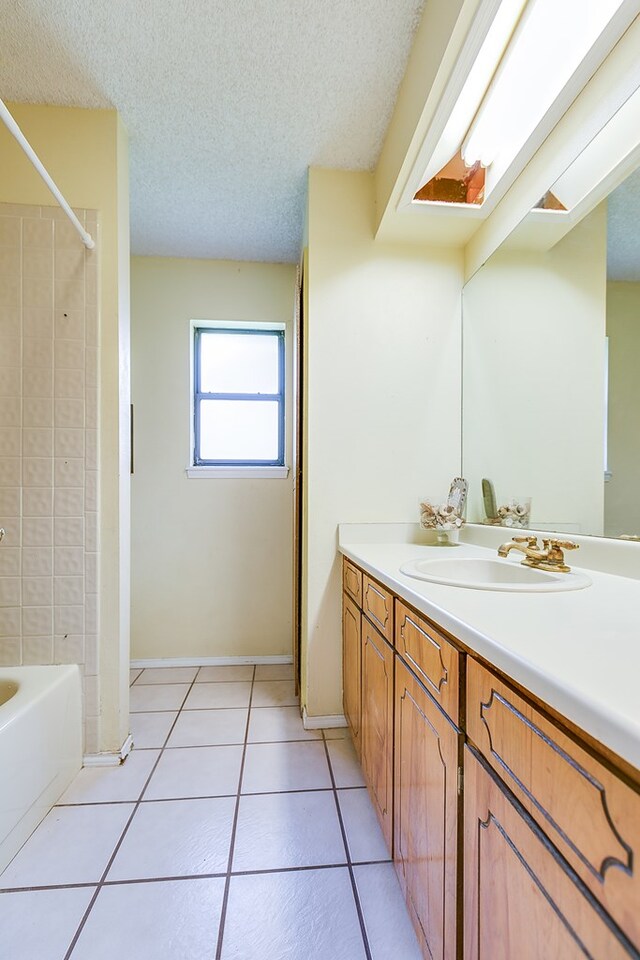 bathroom featuring vanity, tile patterned floors, and a textured ceiling