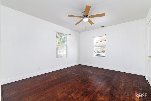 101 W 31st St, San Angelo, TX 76903 - unfurnished room with dark wood-style floors, baseboards, and a ceiling fan