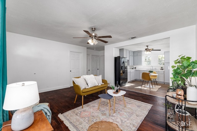 101 W 31st St, San Angelo, TX 76903 - living room with ceiling fan, wood-type flooring, and baseboards