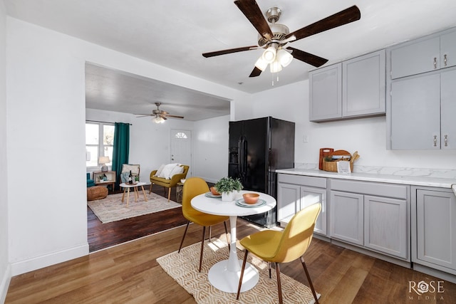 101 W 31st St, San Angelo, TX 76903 - dining space featuring a ceiling fan, wood finished floors, and baseboards