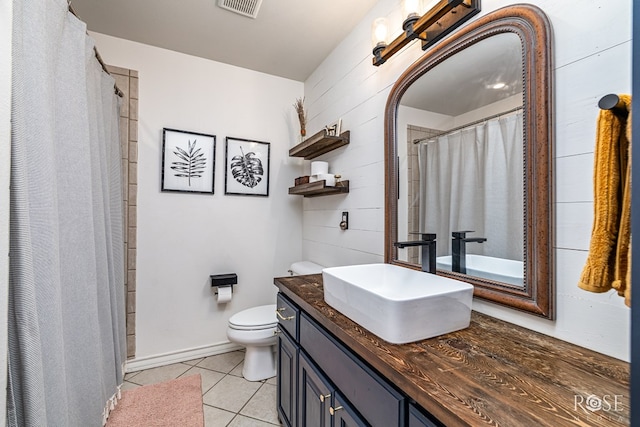 6027 Warwick Dr, San Angelo, TX 76901 - bathroom featuring tile patterned floors, toilet, vanity, and a shower with curtain