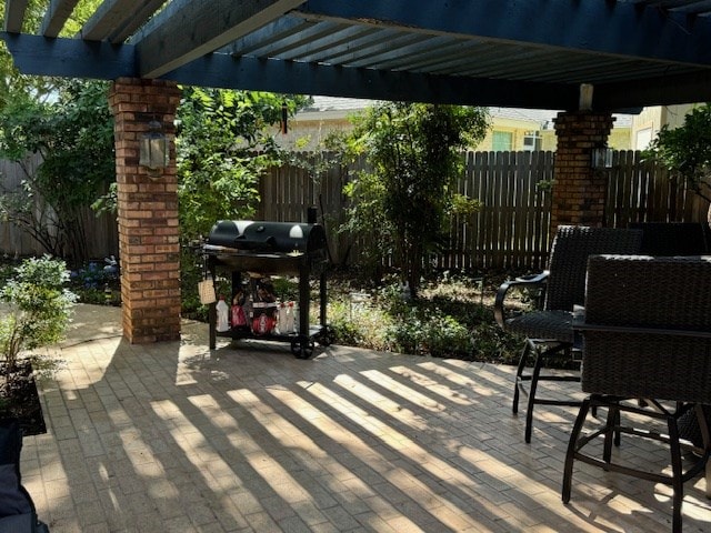 view of patio featuring a grill and a pergola