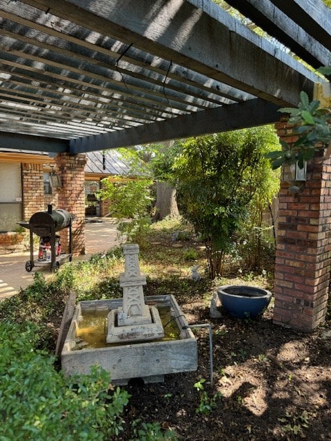 view of patio / terrace featuring grilling area and a pergola