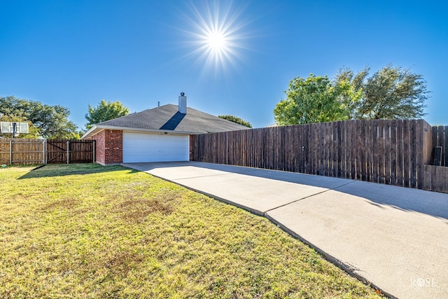 view of property exterior with a garage and a lawn