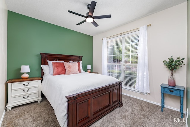 carpeted bedroom with a textured ceiling and ceiling fan