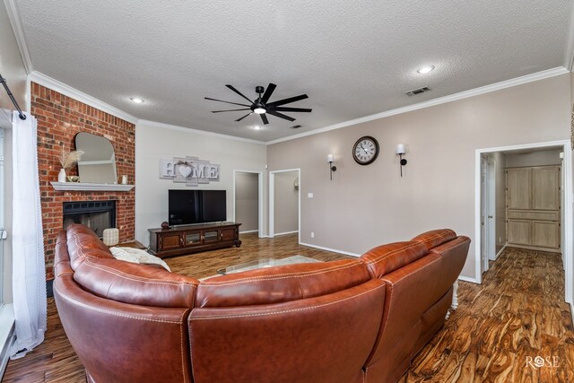 living room featuring crown molding, ceiling fan, dark hardwood / wood-style flooring, and a textured ceiling