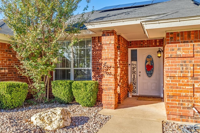 doorway to property featuring solar panels