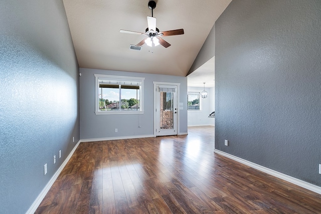 empty room featuring ceiling fan, lofted ceiling, and dark hardwood / wood-style flooring