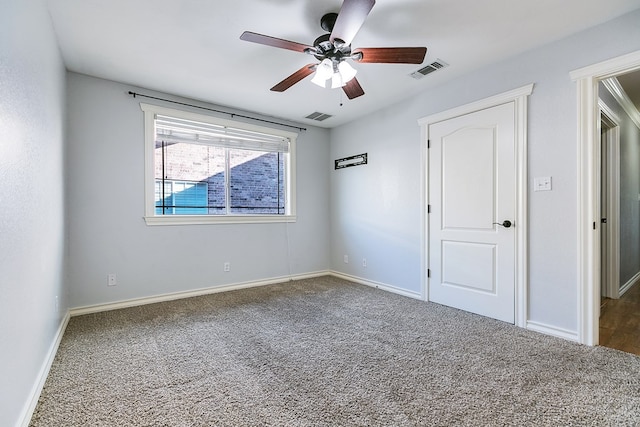 carpeted spare room featuring ceiling fan