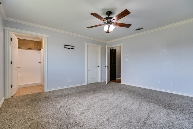 unfurnished bedroom with crown molding, light carpet, ceiling fan, and ensuite bath