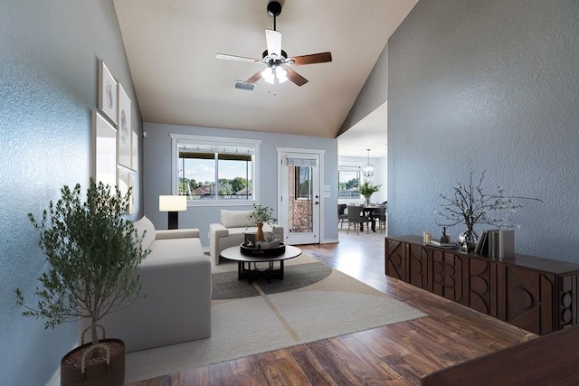 living room featuring hardwood / wood-style flooring, high vaulted ceiling, and ceiling fan