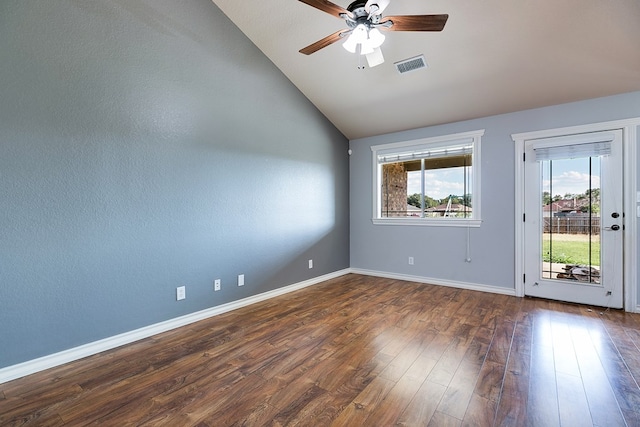 spare room featuring vaulted ceiling, dark hardwood / wood-style floors, and ceiling fan