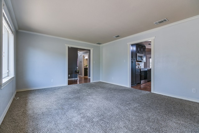 carpeted spare room featuring ornamental molding