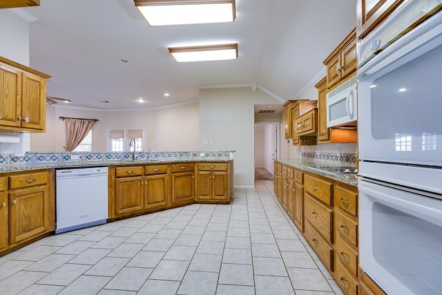 kitchen featuring ornamental molding, lofted ceiling, light tile patterned flooring, and white appliances