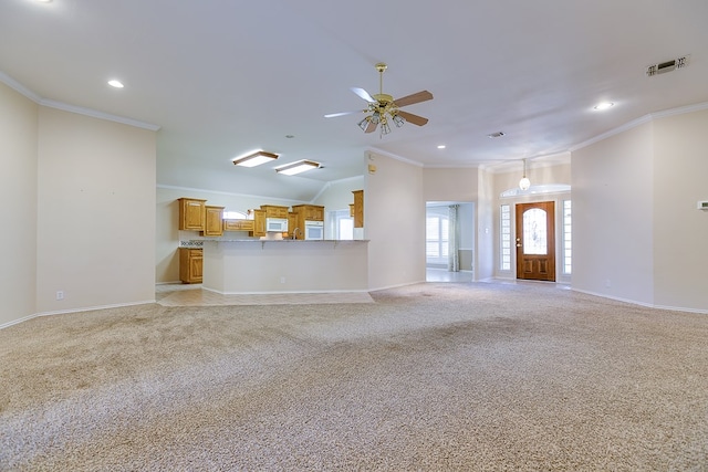 unfurnished living room featuring light colored carpet, ornamental molding, and ceiling fan