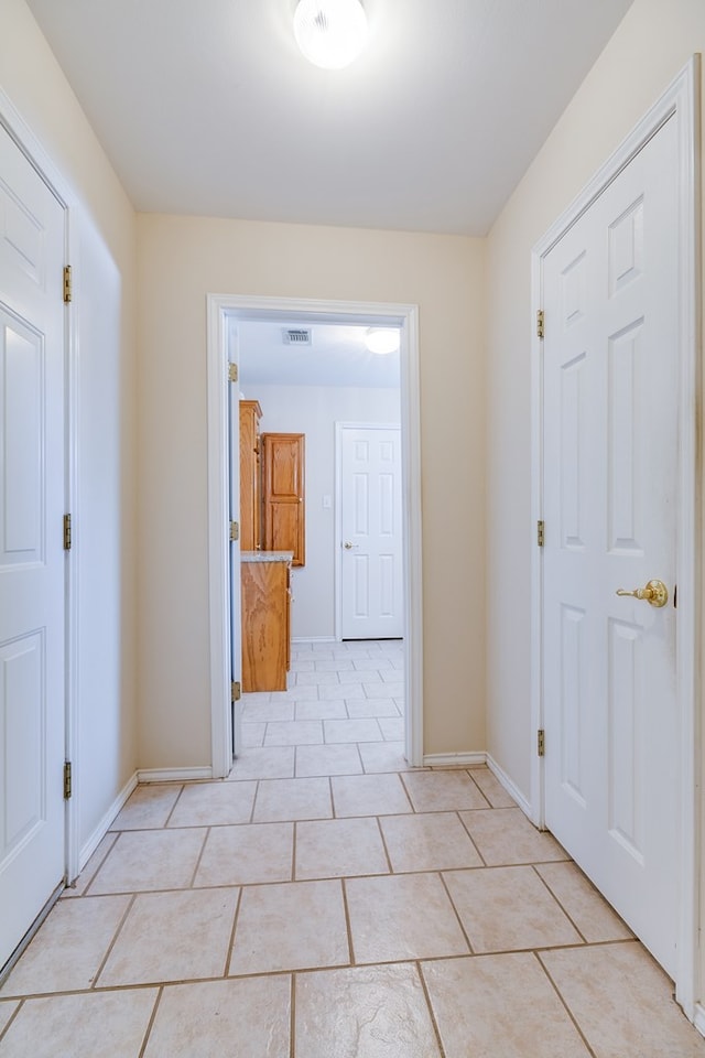 corridor with light tile patterned floors