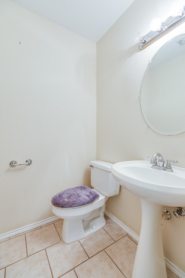 bathroom with tile patterned floors and toilet