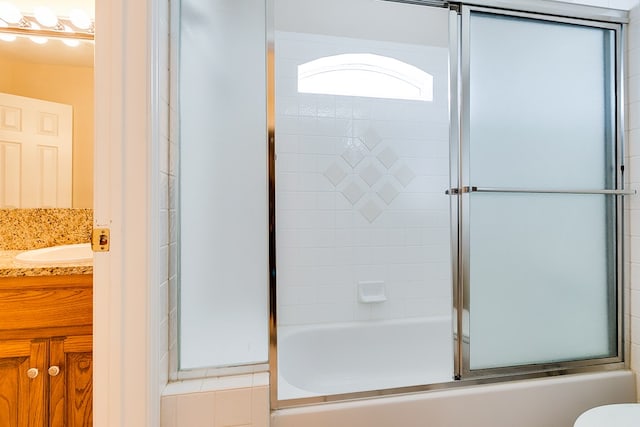 bathroom featuring vanity and shower / bath combination with glass door