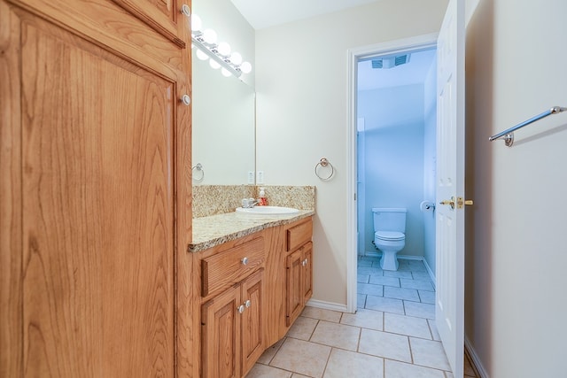 bathroom featuring tile patterned floors, toilet, and vanity