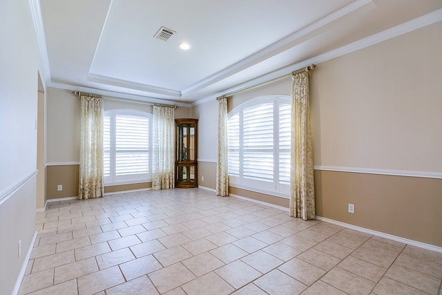 spare room featuring light tile patterned floors, crown molding, and a raised ceiling